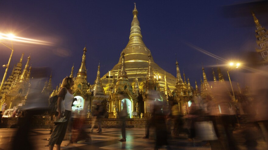 A foreigner pauses to look at the glittering Shwedagon Pagoda, a famous landmark in Myanmar, in Yangon in February. The country's tourism industry is racing to keep up with the rush of visitors now that Myanmar is opening to the outside world.