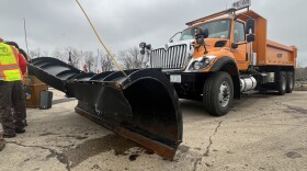 A large, orange Illinois Department of Transportation snow plow at a press conference Thursday.