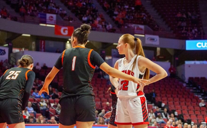 Girls high school basketball players inside an arena
