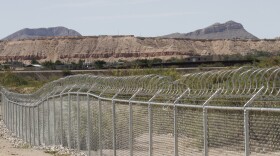 A privately owned fence extends toward the U.S. border, with Mexico in the distance, where restaurant co-owner Robert Ardovino has attempted to route migrants around the center of his property, shown Thursday, Aug. 22, 2024 in Sunland, Park, N.M. Ardovino has a close-up view of border enforcement efforts and bristles at politicians talking from afar about an "open border." The politics of immigration look different from communities on the Southwest border that are voting in hotly contested congressional races. (AP Photos/Morgan Lee)