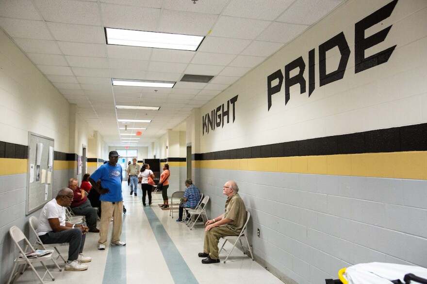 People gather inside Knightdale High School, which has been converted to an evacuation shelter for those affected by Hurricane Florence in Kinghtdale, N.C., Sunday, Sep. 16, 2018.