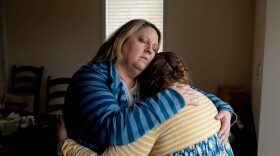 Amy Cupp hugs her daughter, G, for a portrait in her home in northern Indiana. G is 12 and has multiple disabilities. Cupp has filed a federal complaint over G's treatment in school but says the process stalled after President Trump's cuts to the U.S. Education Department.