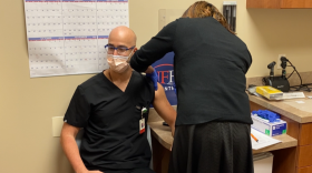 Pharmacist Erika Jasper administers the Pfizer-BioNTech vaccine to Dr. Elias Maroun. Photo: Joe Byrnes