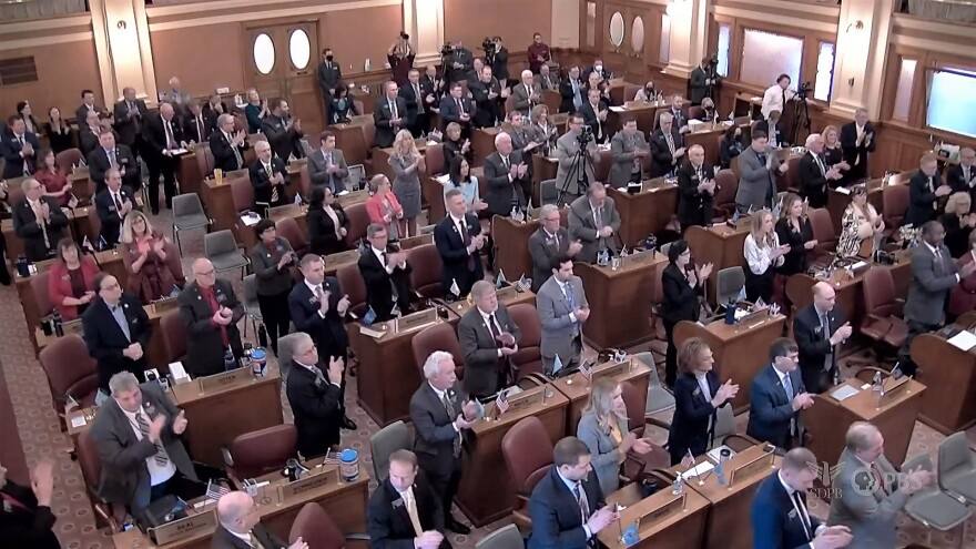 Lawmakers clap on Tuesday during a joint session of the legislature as the governor gives her state of the state speech.