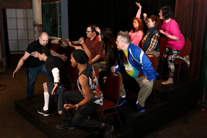 Security man Steve Wilkos, played by Matt Hill, holds back the Springer studio audience in New Line Theatre's "Jerry Springer: The Opera." 