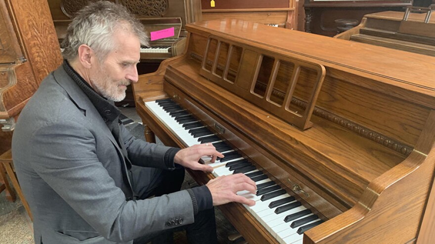 Stephen Merriman plays one of the many pianos in his shop, Merriman's Piano, on March 27, 2020.