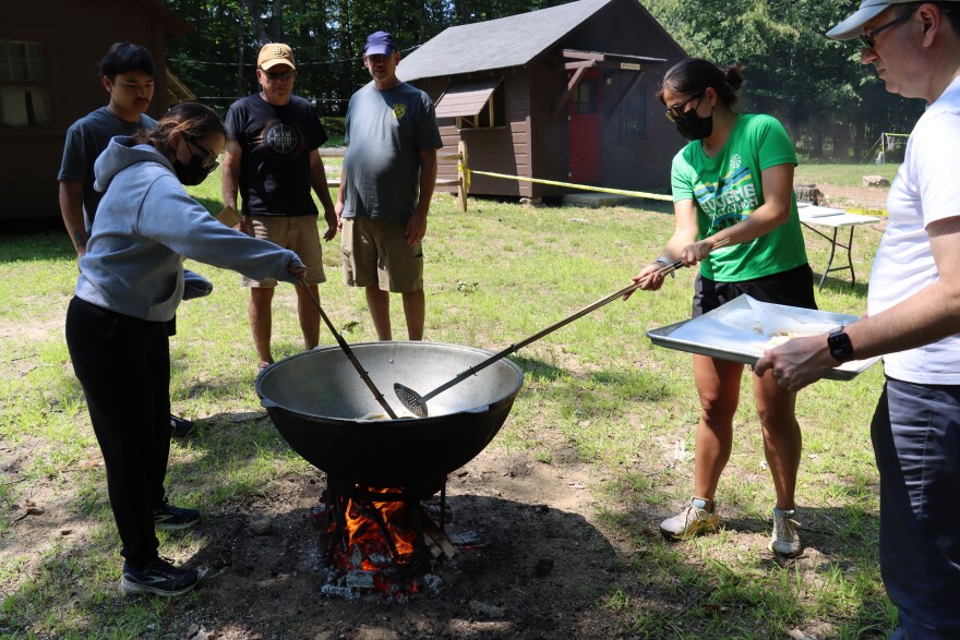 Campers at Zhailau deep fry dough in a metal cauldron to make barsauk, a traditional Kazakh food.