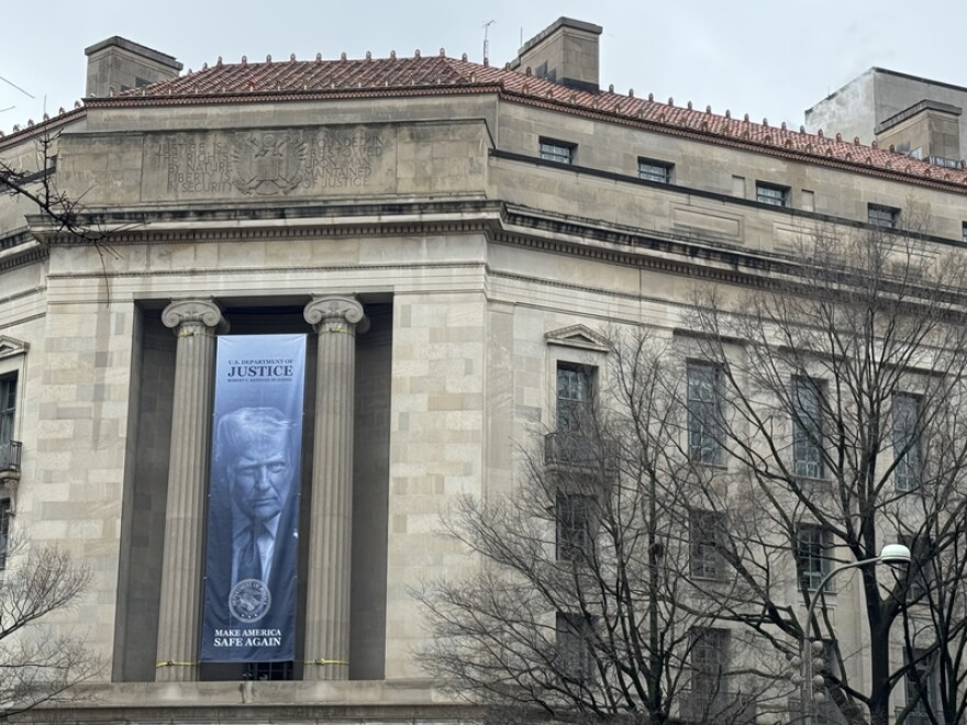 A banner showing President Donald Trump hangs on the U.S. Department of Justice on Feb. 20, 2026.