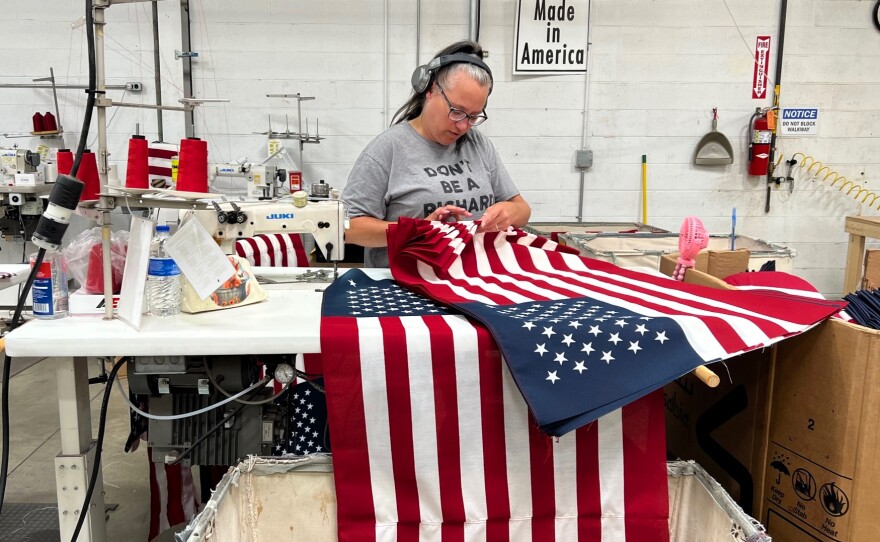 Workers at Annin Flagmakers' Coshocton factory assemble American flags.