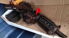 A rifle lying in an open box.