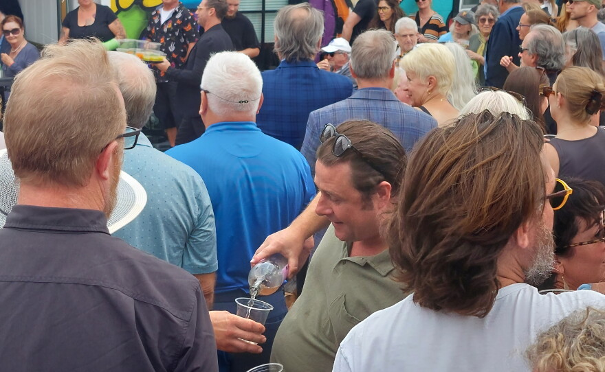 Residents pour drinks at Tommy York's memorial service.