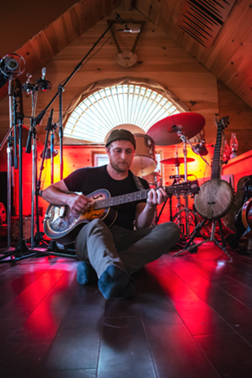 Lipp plays his resonator guitar at home in Temple Cabin Studios, where he records and produces music for himself and his friends.