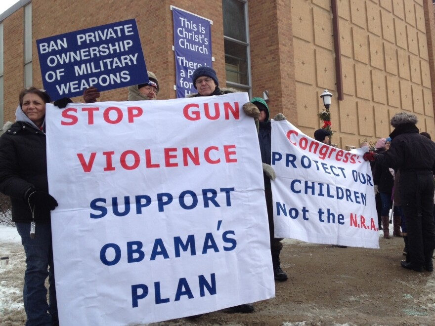 Supporters of gun control laws await President Obama's appearance Monday outside the Minneapolis Police Department's Special Operations Center.