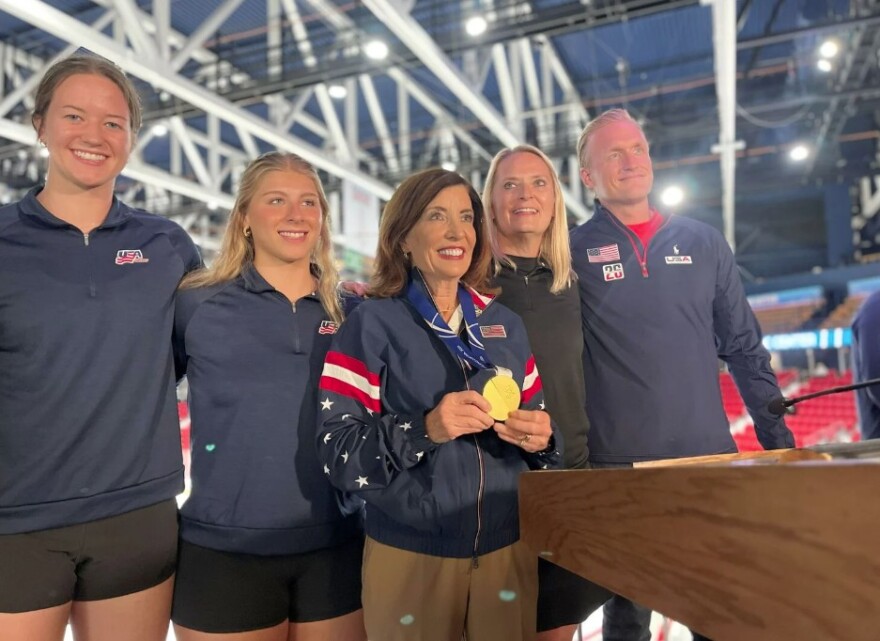 Gov. Kathy Hochul spoke with some American hockey players, including Ava McNaughton, a goalie for the Olympic team that recently won gold in Milan.