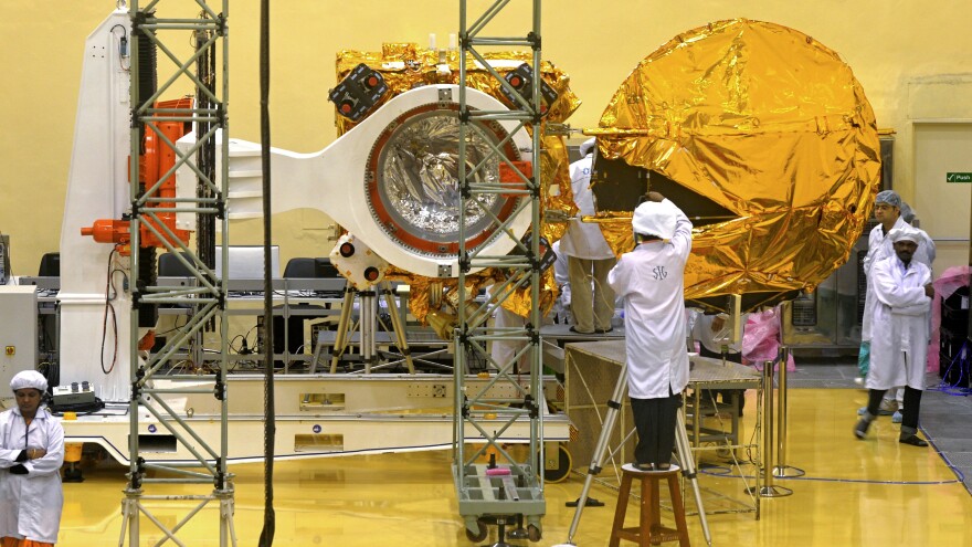 Scientists and engineers work on the Mars Orbiter at the Indian Space Research Organisation's satellite center in Bangalore, India, on Sept. 11. The spacecraft is scheduled to be launched sometime in the next three weeks.