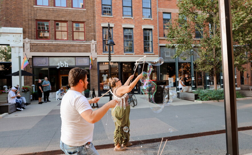 Community members enjoy a fun evening with giant bubbles at the Landing.