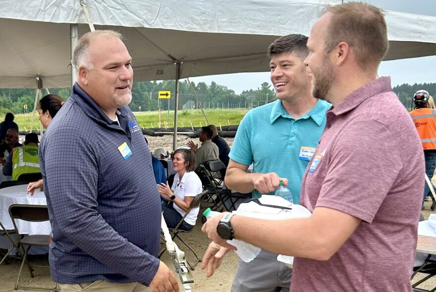 Josh Skelton greets two participants of the Boswell Solar groundbreaking event outside.