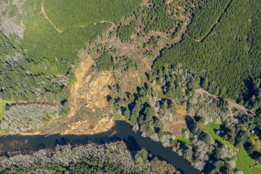 An aerial photo from May shows the massive December landslide that swept down off Weyerhaeuser property, across Oregon Highway 229 and destroyed or damaged houses along the Siletz River.
