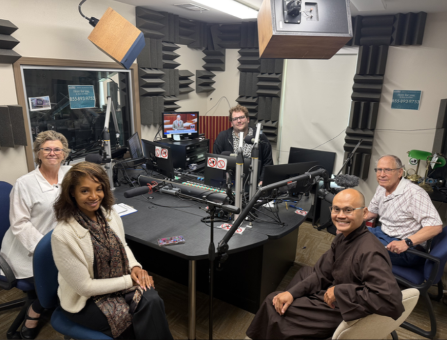 From left to right: Rev. Robin McCullough-Bade, an ordained Evangelical Lutheran minister and former director of the federation; Ma’at Latham, current executive director of the federation and member of the Church of God in Christ; WRKF's Alex Cox; Nguyen An, also known as “Brother Fred,” a monk at the Tam Bao Meditation Center; and Joel Goldman, a retired veterinarian and Hebrew teacher.