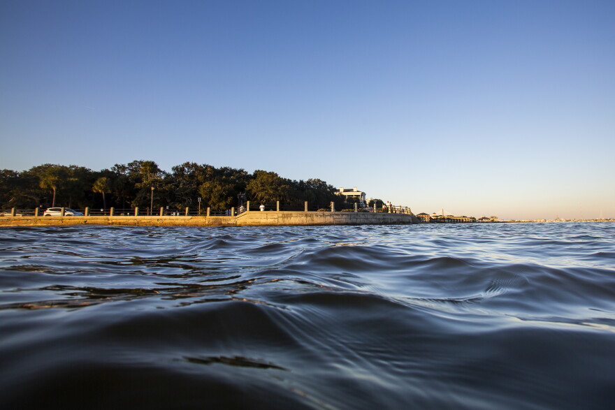 As high tide laps against the sea wall, tourists walk down the Battery in Charleston, South Carolina, in November 2020. According to a U.S. federal report released on Tuesday, Feb. 15, 2022, seas lapping against America’s coastlines are rising ever faster and will be 10 to 12 inches higher by the year 2050 with major U.S. Eastern cities regularly hit with costly sunny day flooding.