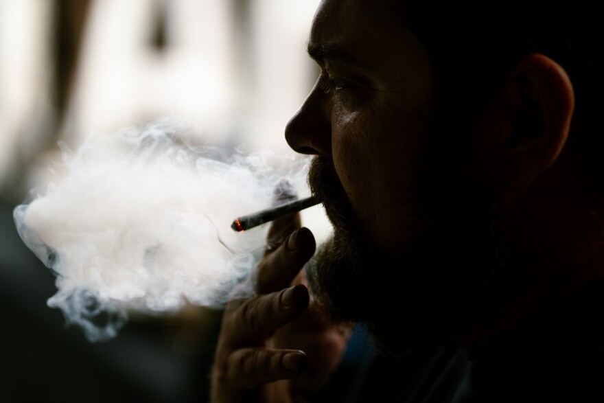 Bobby “Homegrown” Thornton smokes a blunt during a 4/20 celebration at Handlebar on Saturday, April 19, 2025, in St. Louis’ Forest Park Southeast neighborhood.