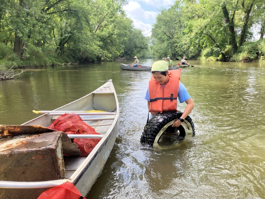 Pictured here - a volunteer helps with river cleanups that have helped remove an estimated 20,000 pounds of trash from Ohio waterways this year.