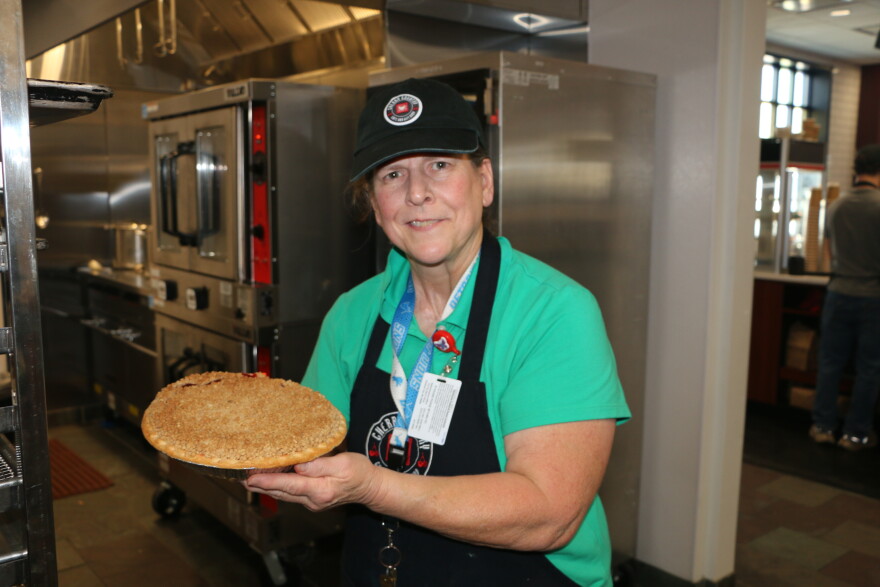 Kathy Kmotorka holding a homemade cherry pie, available at the Cherry Capital Airport Cafe. Kathy has been making food for travelers at the airport for 18 years. (Photo : Austin Rowlader / IPR News)
