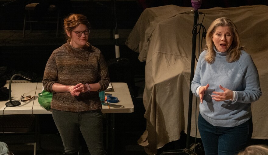 Two women stand next to each other.