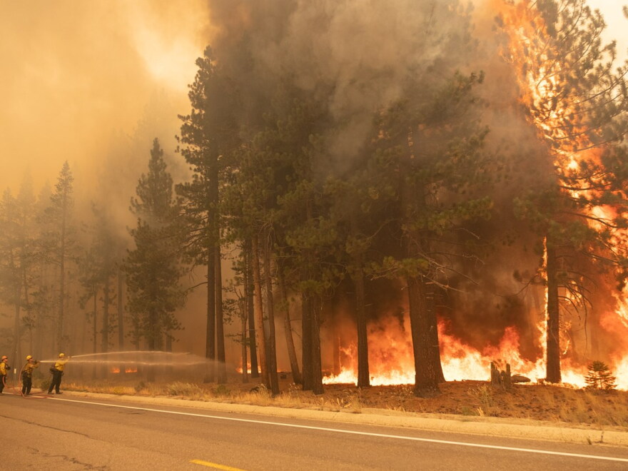 Fire crews fight the Caldor Fire just south of Meyers, Calif. on Tuesday, Aug. 31, 2021.
