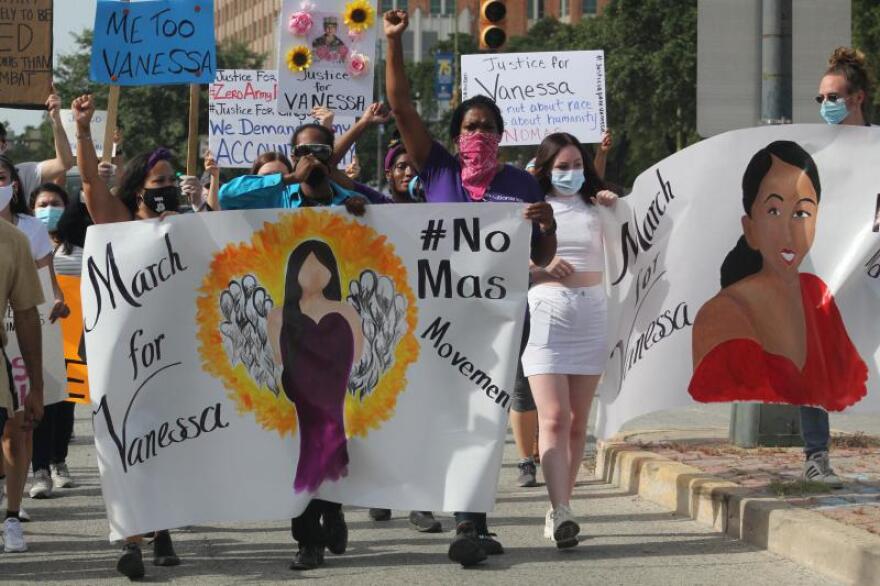 Josey Garcia, Pharaoh Clark, and Jourdyn Parks hold a banner as they march through San Antonio in July, shortly after Vanessa Guillen's body was found near Fort Hood.