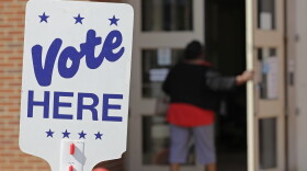 File photo of polling worker as she enters a polling place in Charlotte, N.C., Wednesday, April 24, 2019 as early voting began in the Republican primary election for the North Carolina 9th Congressional District, a special election that was forced after last year's race was voided by a ballot-collection scandal. 