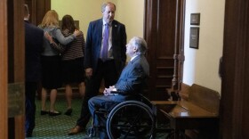 Opening Day action of the 88th Texas Legislature at the Texas Capitol showing Attorney General Ken Paxton conferring with Gov. Greg Abbott outside the Senate chamber before his swearing in ceremony in Jan. 10, 2023