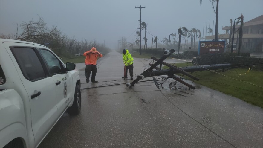A utility pole blocks the road in Saipan on Wednesday, April 15, 2026, as a super typhoon with ferocious winds and relentless rains, shredded tin roofs and forced residents to take cover from flying tree limbs.