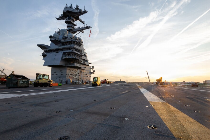 Pre-Commissioning Unit John F. Kennedy sits moored at the Newport News Shipyard pier in the James River.