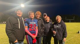 Rylan Reece, 16, poses with his family in his football uniform