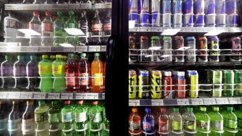 FILE - Soft drinks fill a drink cooler in a convenience store. (AP Photo/Elaine Thompson, File)