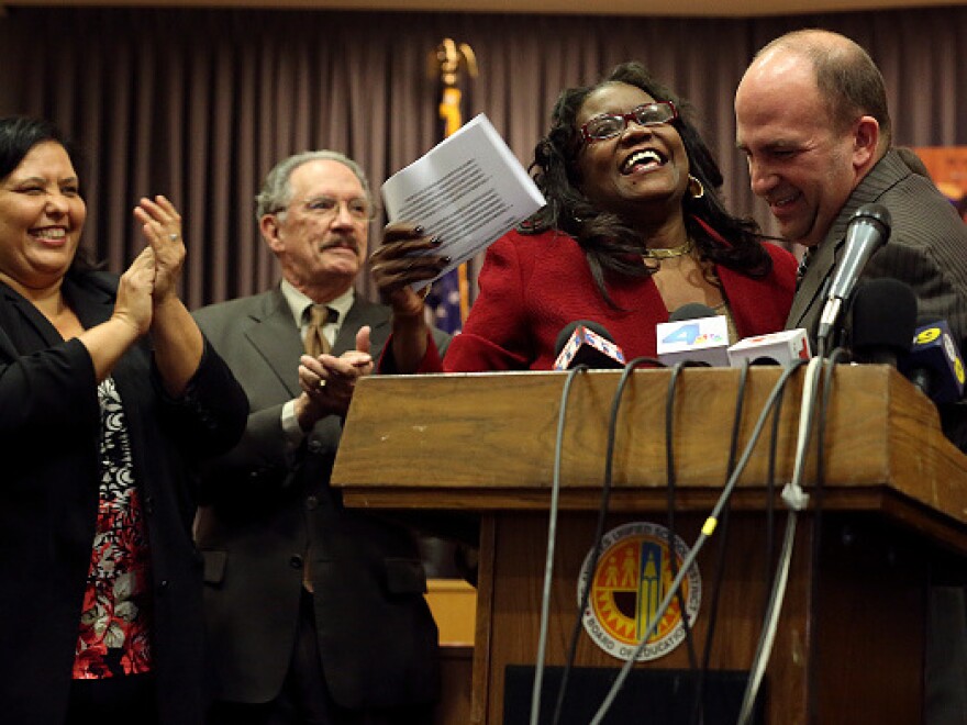 Michelle King is introduced by the school district board member and president, Steve Zimmer, right, as the new superintendent.