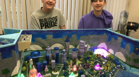 From left: Eighth graders Jack Garrison and Daniel Dacey stand behind their model city named Aquawen.