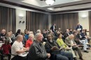 People sit in nearly every chair in Hamilton's City Council Chambers.
