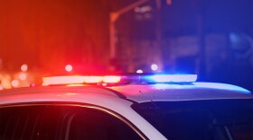 Close-up of the blue and red lights on top of a police vehicle at night.