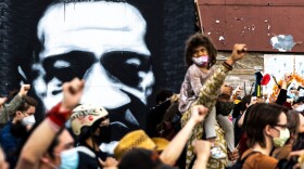People raise their fists during a demonstration near the George Floyd Memorial in Minneapolis, Minnesota on April 18, 2021 after the shooting death of Daunte Wright. (Kerem Yucel/AFP via Getty Images)