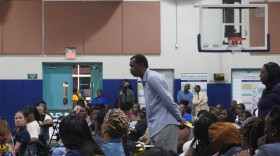 An attendee takes the microphone to voice his concerns as county officials field questions during the Oct. 8 meeting at the NFL YET Center.