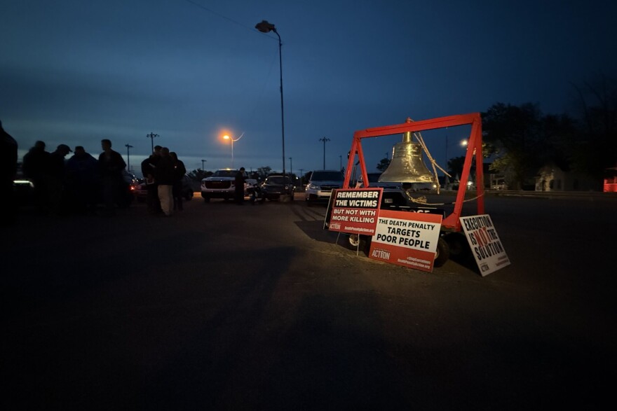 The "Delaware Bell" sits outside the Indiana State Prison, surrounded by protest signs