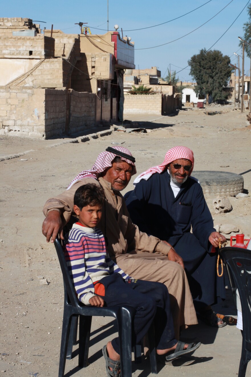 Asaad Abdullah (center) took his son, Barzan (left), out of the ISIS school because he didn't like the curriculum. He hopes normal schools will reopen soon.