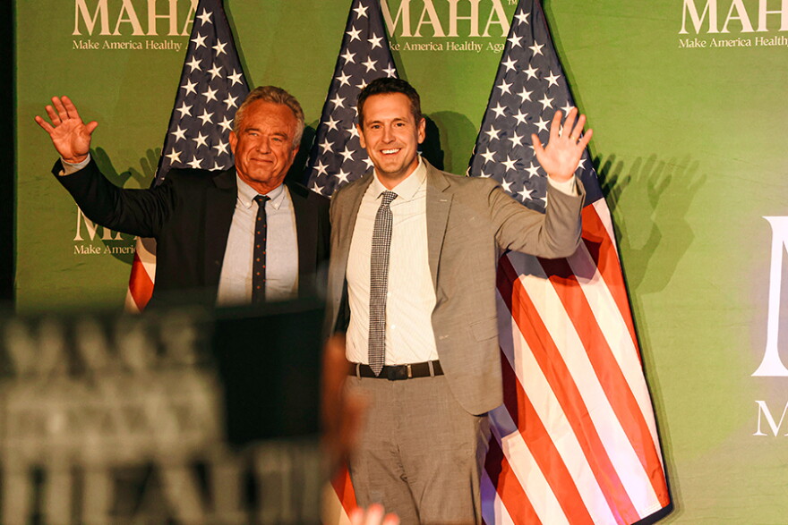 HHS Secretary Robert F. Kennedy Jr. (left) stands with Republican gubernatorial candidate Zach Lahn at a rally in Clive organized by MAHA PAC, the political arm of the Make America Healthy Again movement, on October 17, 2026.