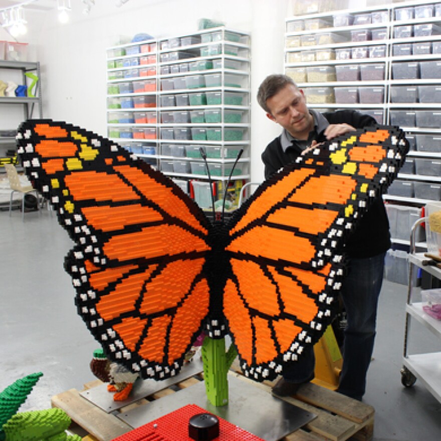 Sean Kenney works on a LEGO butterfly.