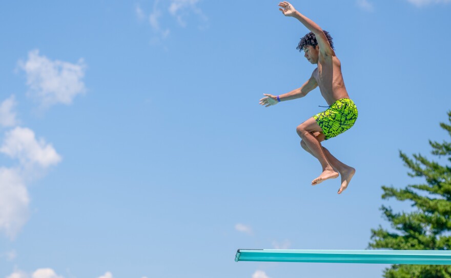 Dante Cobb, 14, jumps from the highest diving board at the Kingston Community Pool.