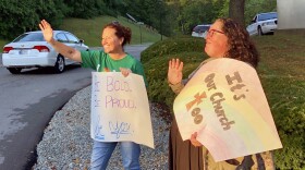 Shelly Fitzgerald waves to students entering Cathedral High School's campus. Fitzgerald was a guidance counselor at Roncalli High School before being put on administrative leave last year due to her same-sex marriage.