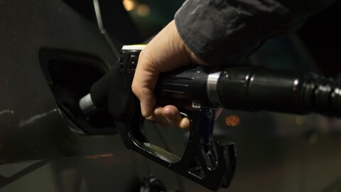 Pumping gasoline for a vehicle.