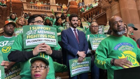 Members of District Council 37 rally at the capitol for pension changes for public employees. At the lectern is Donald Nesbit.